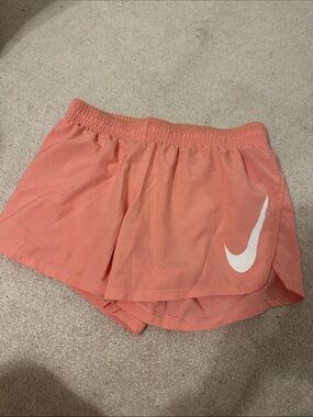 Nike Women's Coral Pink Athletic Running Shorts with White Swoosh